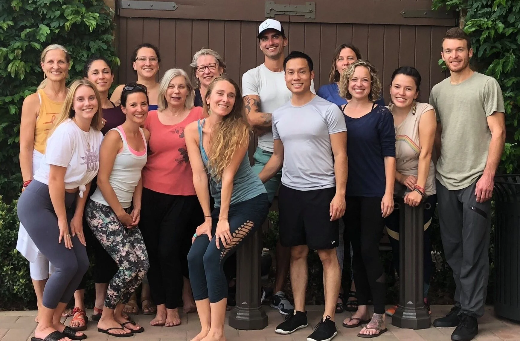 A Neurogenic Yoga and TRE training group gathered together outdoors after a session